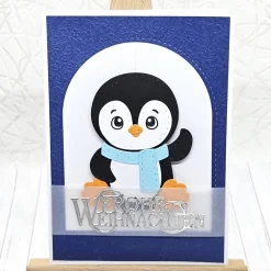 Weihnachtskarten|Kleine Schätze Handgemachte Weihnachtskarte A6 Pinguin mit blauem Schal | Unikat mit Umschlag & Dekoanhänger