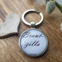 Accessoires|Die Schmuckkiste Schlüsselsanhänger Brautzilla Hochzeit schwarz weiß Cabochon silberfarbe Fassung 25mm lustiges Geschenk